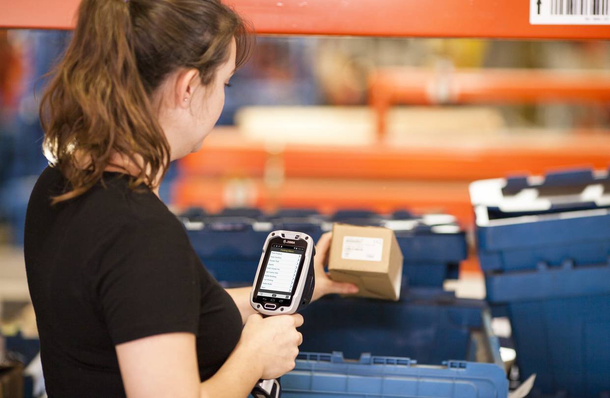 Warehouse worker using a scanning device.